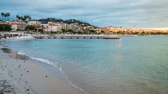 Croisette beach and Cannes cityscape at dusk in Cannes France