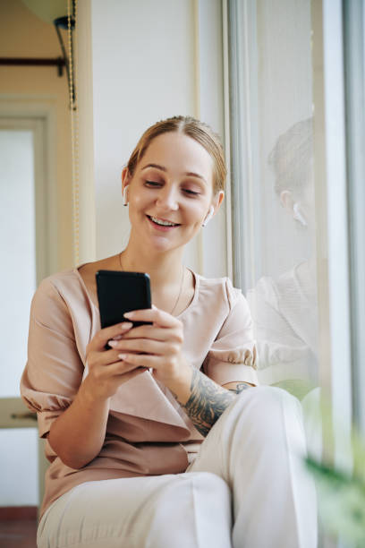 istock Happy Woman Choosing Playlist 1199448114
