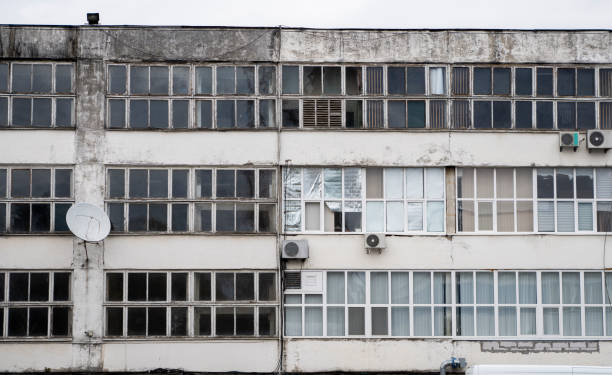 istock The front view on a facade of building with wall and windows in soviet architecture style. 1199452583
