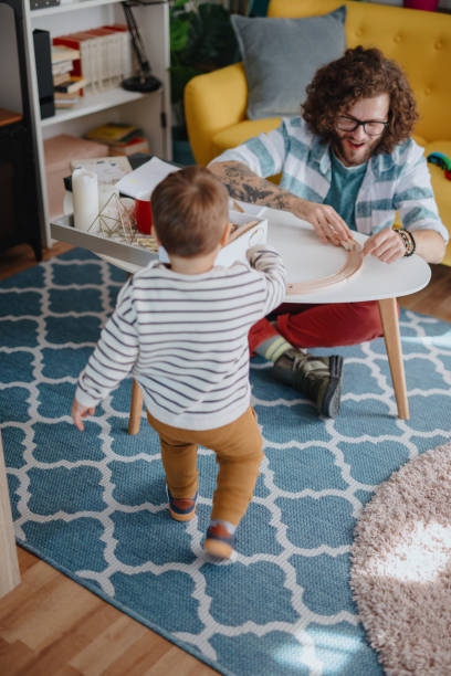 istock Millennial dad and son playing with wooden toy 1199452820