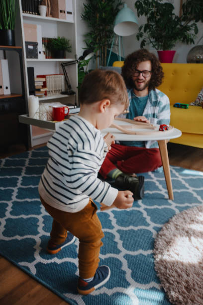 istock Millennial dad and son playing with wooden toy 1199452890