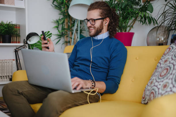 istock Millennial man video chatting with friend 1199453083