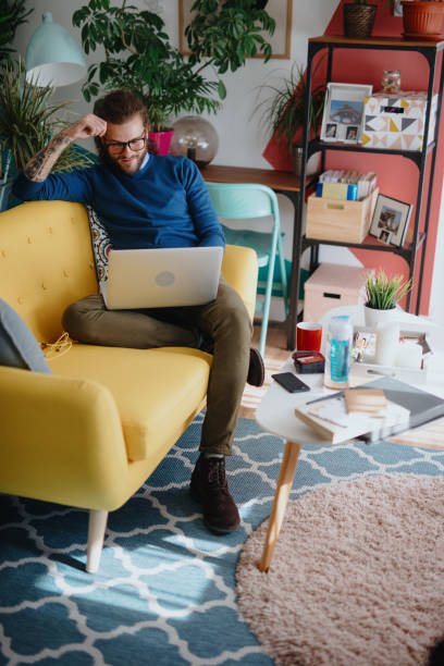 istock Millennial man shopping online 1199453133