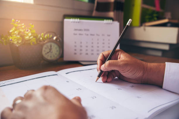 istock man mark and noted schedule on book or diary 1199453279
