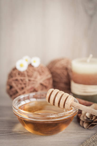 istock Honey and honey dipper on the table 1199453886