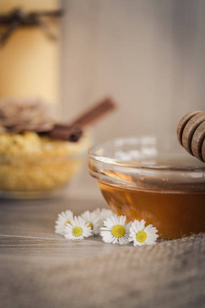 istock Fresh chamomile flowers and honey 1199453897