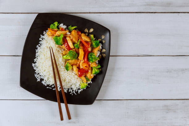 istock Asian stir fry meat, vegetables with white rice. 1199454034