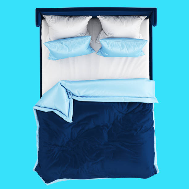 istock A soft blue double bed with blue and white bed linen on a blue background. Top view. 3d rendering 1199454473
