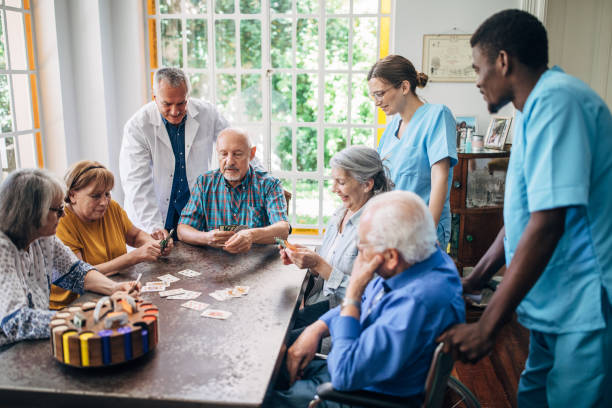 istock Senior people playing cards and having fun in nursing home 1199454861