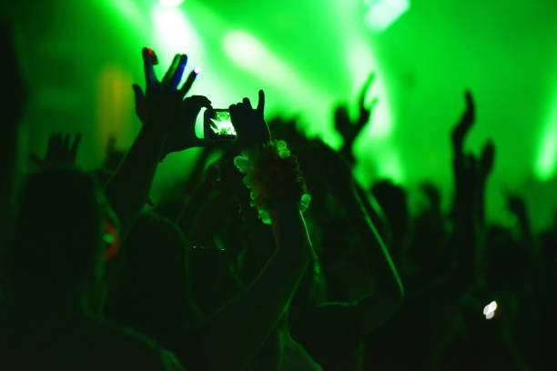 istock Hand holding smart phone and recording concert 1199454962