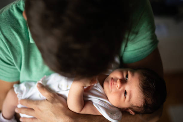 istock Father holding newborn baby 1199455029