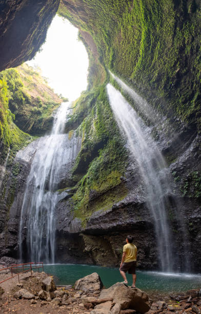 istock Majestic waterfall flowing on rocky cliff in tropical rainforest 1199455111