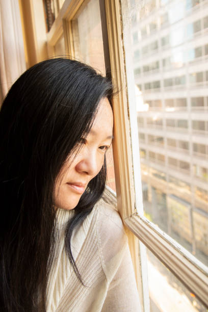 istock Beautiful Korean Woman by a Window 1199456674