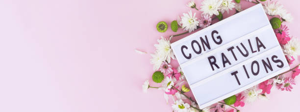 istock Congratulatory banner with lightbox and flowers on a pink background. 1199457354