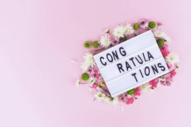 istock Beautiful greeting composition with flowers on a pink background. 1199457412