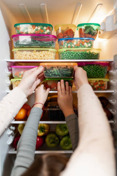 istock Mother and daughter preparing food 1199457762