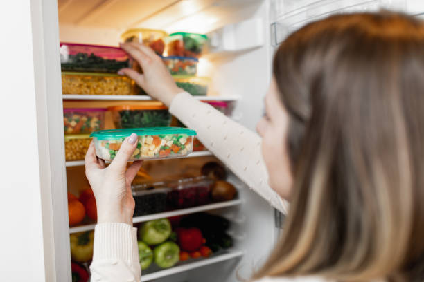 istock Woman taking raw food from refrigerator 1199457810