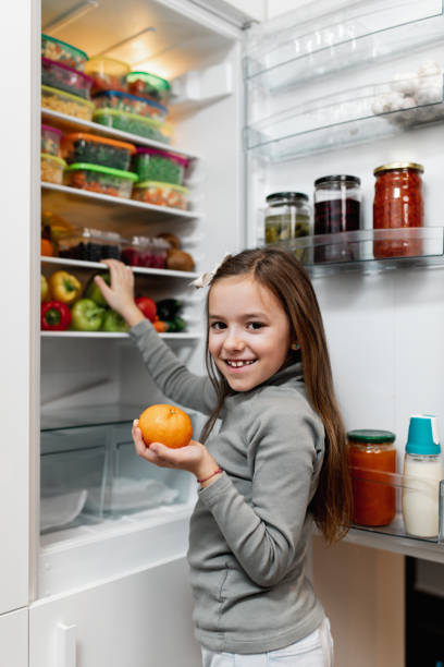 istock Girl taking raw food from refrigerator 1199457872