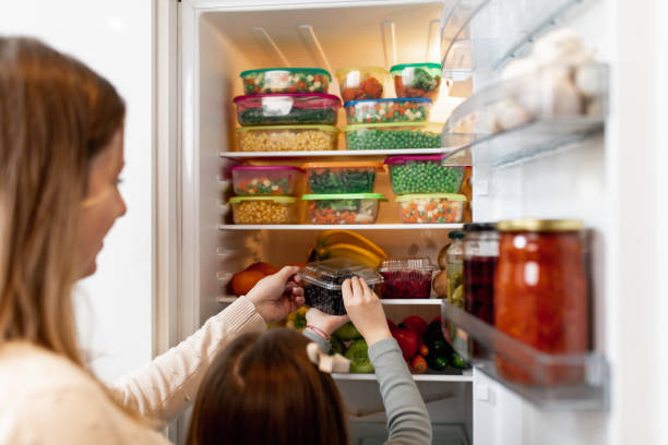istock Mother and daughter preparing food 1199457895