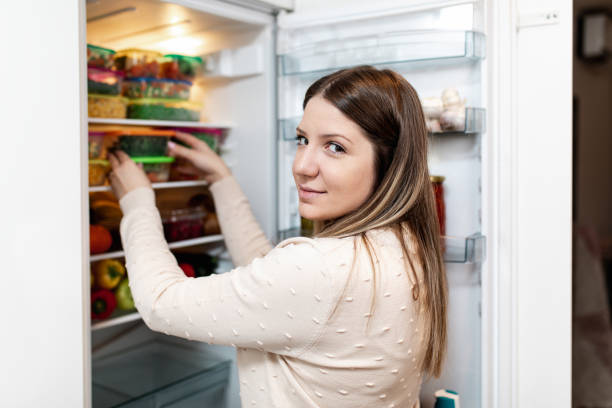 istock Woman taking raw food from refrigerator 1199457899