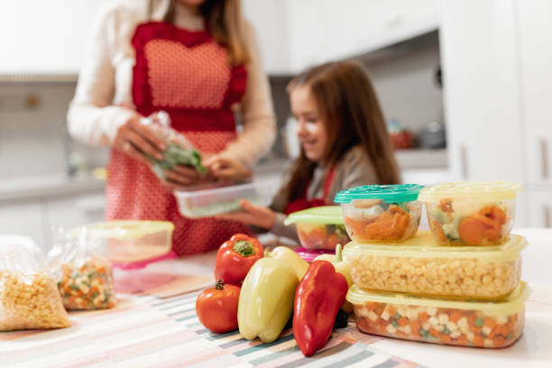 istock Mother and daughter preparing food 1199457912