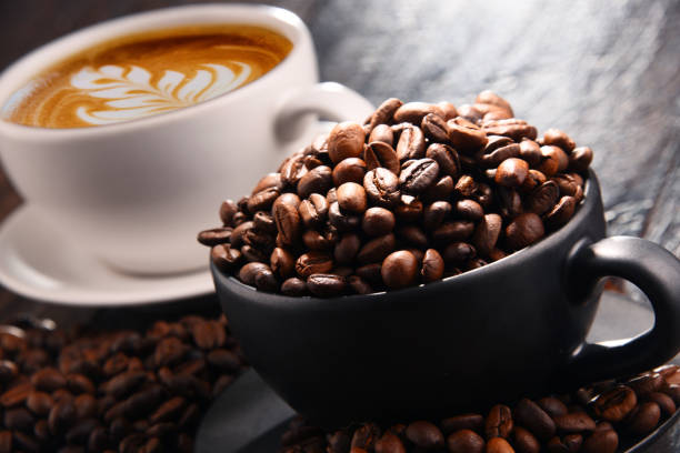 Composition with two cups of coffee and beans.