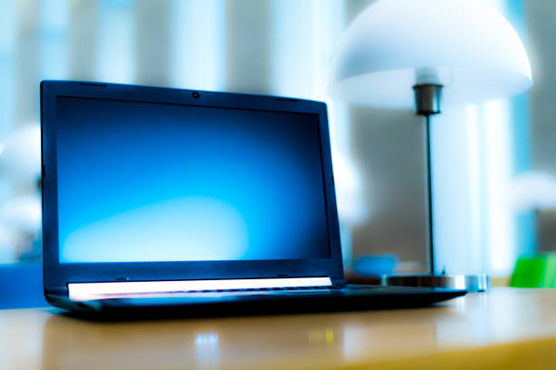 istock Laptop computer on the desk in public library 1199460243