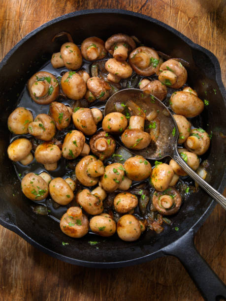 Butter and Garlic Mushrooms with Onions Butter and Garlic Mushrooms with Onions crimini mushroom stock pictures, royalty-free photos & images
