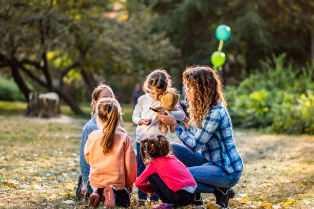 istock Group of small kids enjoying on autumn day outdoors while exploring the environment 1199462138