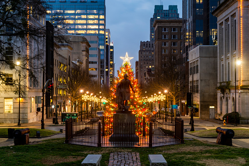 Downtown Raleigh NC during Christmas, back of statue of George Washington ( cast by William J. Hubbard in 1857) looking down Fayetteville street.
