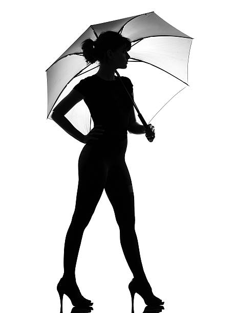 istock one silhouette woman holding under open umbrella 119946605
