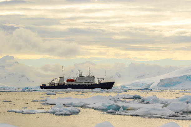 istock Small passenger vessel between ice in Antarctica 1199467128