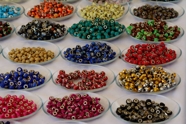 istock Different color jewelry beads on glass plates 1199467652