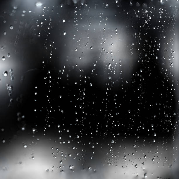 rain water drops on a black dramatic window glass. autumn  depression background. rain pattern"n - wet dew drop steam imagens e fotografias de stock