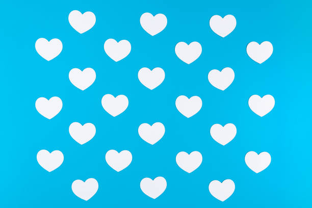 istock A group of white hearts placed on the blue background like a chessboard pattern 1199468931