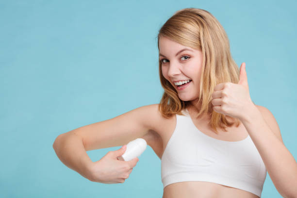 istock Girl applying stick deodorant in armpit. 1199470444