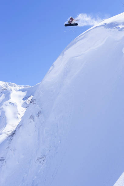 istock Snowboarding jumping off a snow windlip. 1199471989