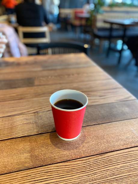 istock coffee in a red paper cup on a wooden table 1199472573