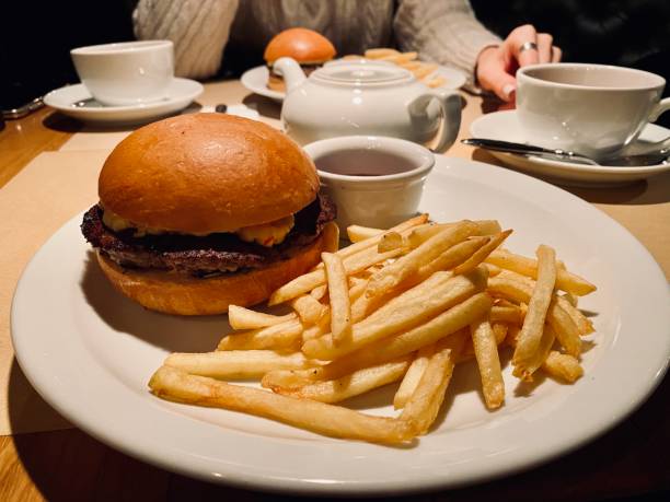 istock cheeseburger and fries in a cafe 1199473716