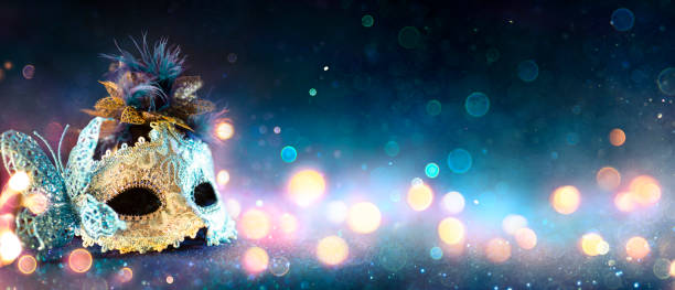istock Carnival Mask With Bokeh Lights On Blue Glitter 1199474431