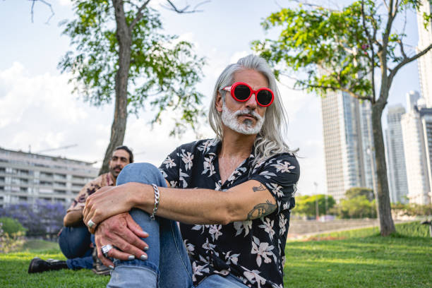 Senior man sitting on a grass area
