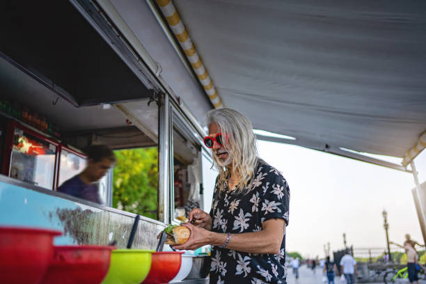 istock Senior adult man making himself a burger 1199476295