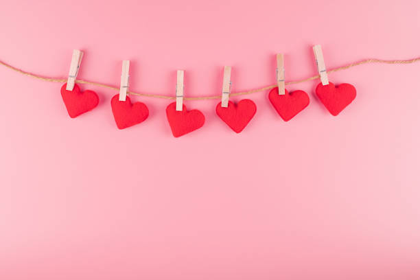 istock Red heart shape decoration hanging on line with copy space for text on pink background. Love, Wedding, Romantic and Happy Valentine day holiday concept 1199476306