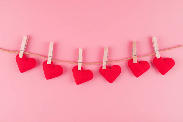 istock Red heart shape decoration hanging on line with copy space for text on pink background. Love, Wedding, Romantic and Happy Valentine day holiday concept 1199476331
