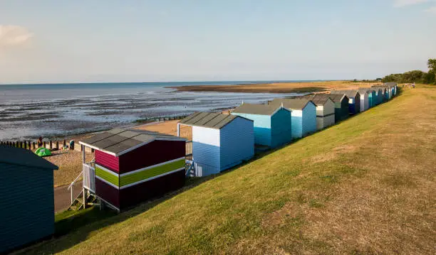 Multi-coloured holiday wooden beach huts facing the ocean  on the beach of Tankerton Whitstable coast,  Kent district England.
