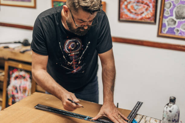 istock Man measuring canvas for painting 1199477752