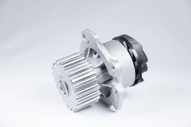 New metal automobile pump for cooling an engine water pump on a gray background with a gradient. The concept of new spare parts for the car engine stock photo