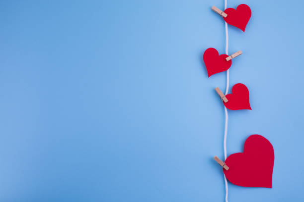 istock Valentine's day abstract background with paper cut red hearts decoration, flat layout, empty space for text 1199478904