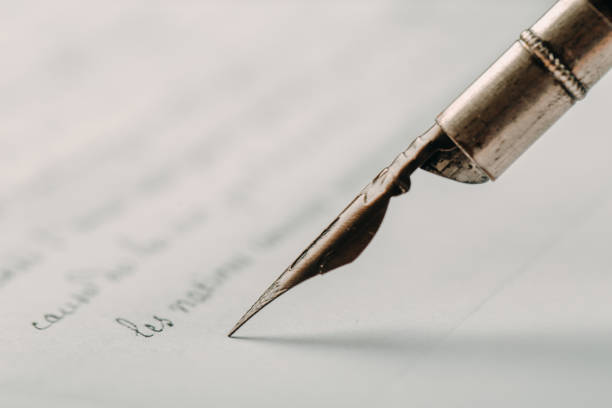 istock fountain pen on paper with ink text closeup 1199479834