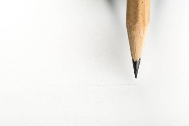 Pencil on hand holding for writing answer of test examination